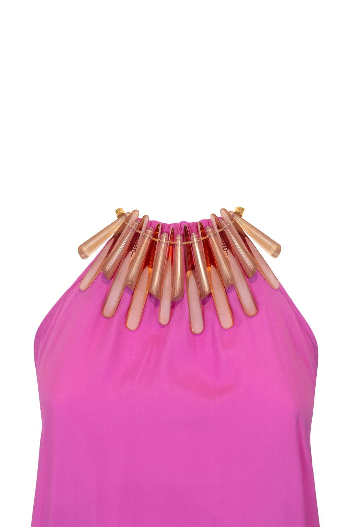 Bright pink dress with a statement necklace featuring elongated, transparent beads.